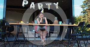 Lame birthday party on quarantine. Sad upset Caucasian young beautiful woman sits alone at home with cake slow motion.