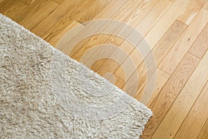 Laminate parquete floor. Light wooden texture. Beige soft carpet