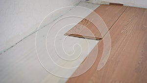 Laminate, the structure of wood, wooden boards and insulating substrate. View of the process of installation and installation of