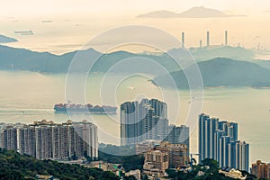 Lamma Island viewed from Victoria Peak on Hong Kong Island in Hong Kong. Container vessel transports cargo East Lamma Channel