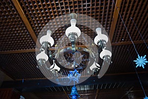 The lamp in the beautiful room . Chandelier ceiling lights . luxury expensive chandelier hanging under ceiling in palace.