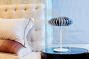 Lamp on bedside table in bedroom