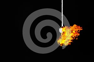 Lamp bulb hanging on the rope. Fire inside. New idea concept