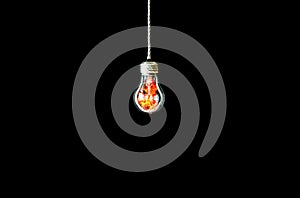 Lamp bulb hanging on the rope. Isolated on black background. Fire inside. New idea concept