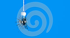 Lamp bulb hanging on the rope. Isolated on blue background. New idea concept