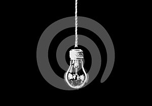 Lamp bulb hanging on the rope. New idea concept. Isolated on black background
