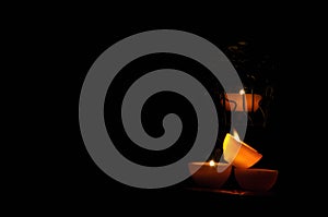 Lamp, candle shining in the darkness. Challis flame. Artistic composition.