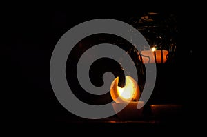 Lamp, candle shining in the darkness. Challis flame. Artistic composition.