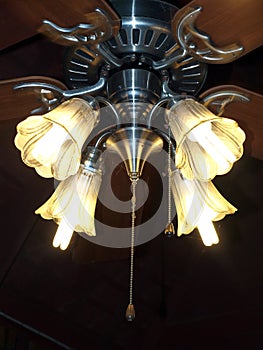 The lamp with ceiling Fan at the night. A ceiling fan is a mechanical fan, usually electrically powered.