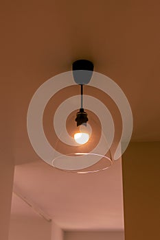 Lamp on the ceiling in the room in orange light