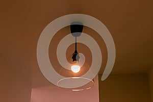 Lamp on the ceiling in the room in orange light