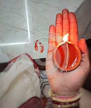 Lamp in hand with blur background of feet printed