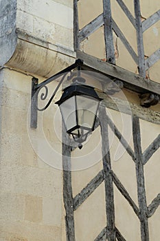 Lamp hanging streetlight in front of old building wall