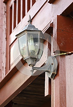 Lamp hanging on wooden wall