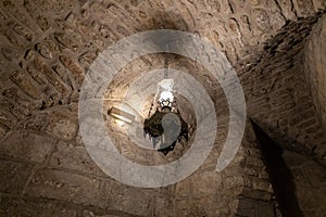 The lamp hangs from the ceiling in the underground hall of the wall of the Church of Nativity in Bethlehem in the Palestinian