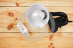 Lamp with installed energy-efficient and eco-friendly led light on the background of outdated incandescent lamps and halogen