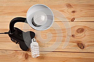 lamp with installed energy-efficient and eco-friendly led light on the background of outdated incandescent lamps and halogen