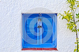Lamp, lamp, hanging on a blue window in Nijar, Almeria, Andalusia, Spain