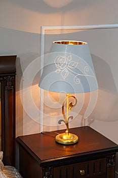 Lamp with a lampshade in the classic style in the bedroom