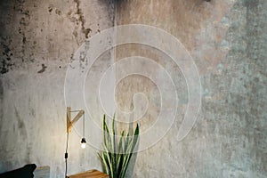 Lamp light bulb on concrete background. Lamp illuminated. Light bulb hang in dark room. There is a place for your text