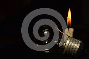 a lamp and one candle blur burning in the dark background, during a power outage.