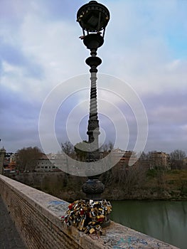 Lamp with padlocks on the Milvian Bridge in Rome