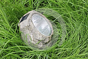 Lamp with photocell in the wet grass