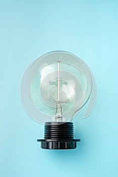 Lamp On Plain Back Ground Presenting New Begining, Bulb On Blue Backdrop Showing New Opinion, One Lightbulb Exhibiting