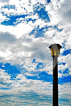 Lamp post and cloudy sky photo