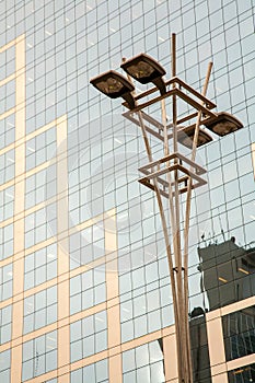 Lamp post in front of a Glass and concrete facade on a modern corporate skycraper building in Brazil photo