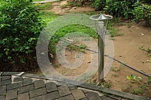 Lamp post with LED energy saving bulb in garden