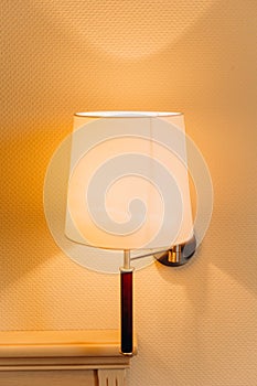 Lamp sconce inside bedroom interior dresser wall