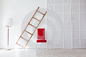 Lamp staircase red chair in the interior of the white room