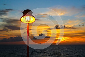Lamp with sunset in the sea.