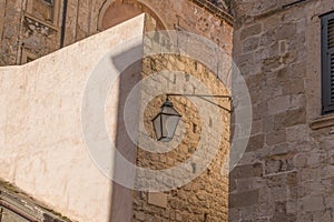 Lamp on the wall of medieval town photo