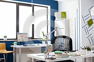 Lamp on a white desk in an empty modern business office.