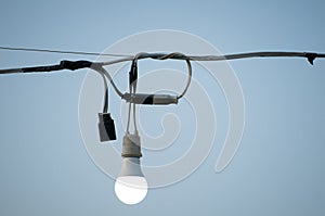 Lamp with wires and sky background