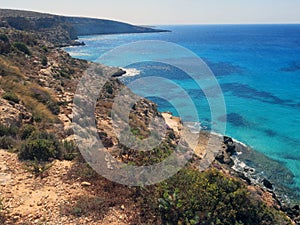 Lampedusa in Italy with Cliff and clean blue sea photo