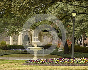 Lampost, flower bed, fountain and gazebo in Flippen Park in Highland Park in Dallas, Texas