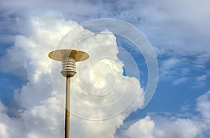 Lamppost against the fluffy white cloud