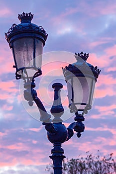 Lampposts with a sunset sky