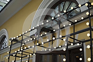 Lamps above entrance. Entrance to bar. Lambing lamps on steel frame. Entrance group in house