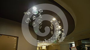 Lamps close-up. Crystal modern chandelier detail background. Hanging lamps in the form of bubbles with a flashing