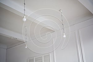 Lamps hang directly from the ceiling with laces and cables. Loft style interior