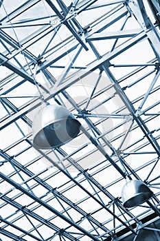 Lamps and metallic girders on glass ceiling