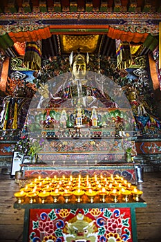 Lamps with statue of Guru Rinpoche and deity , inside of chapel , Bhutan