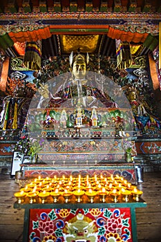 Lamps with statue of Guru Rinpoche and deity , inside of chapel , Bhutan photo