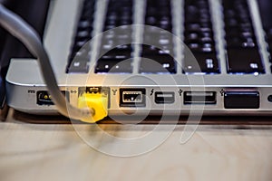 Lan cable is connected to the notebook on table