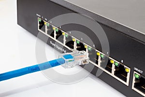 LAN network switch with ethernet cables plugging in