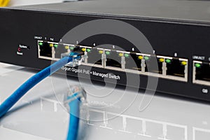 LAN network switch with ethernet cables plugging in